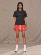 Model wearing the SM Motion Mesh Shorts in Watermelon Tint, front view.