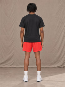 Model wearing the SM Motion Mesh Shorts in Watermelon Tint, rear view.