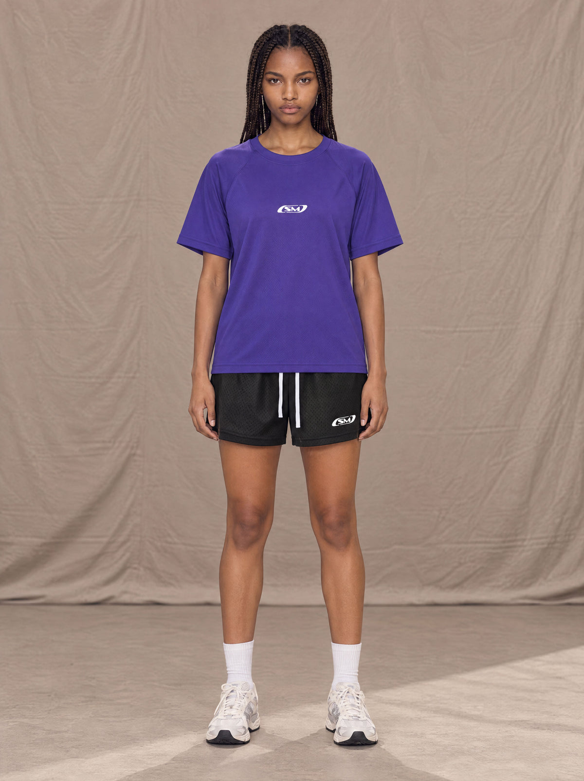 Model wearing the SM Motion Mesh T-shirt in Rich Violet, front view.