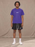 Model wearing the SM Motion Mesh T-shirt in Rich Violet, front view.