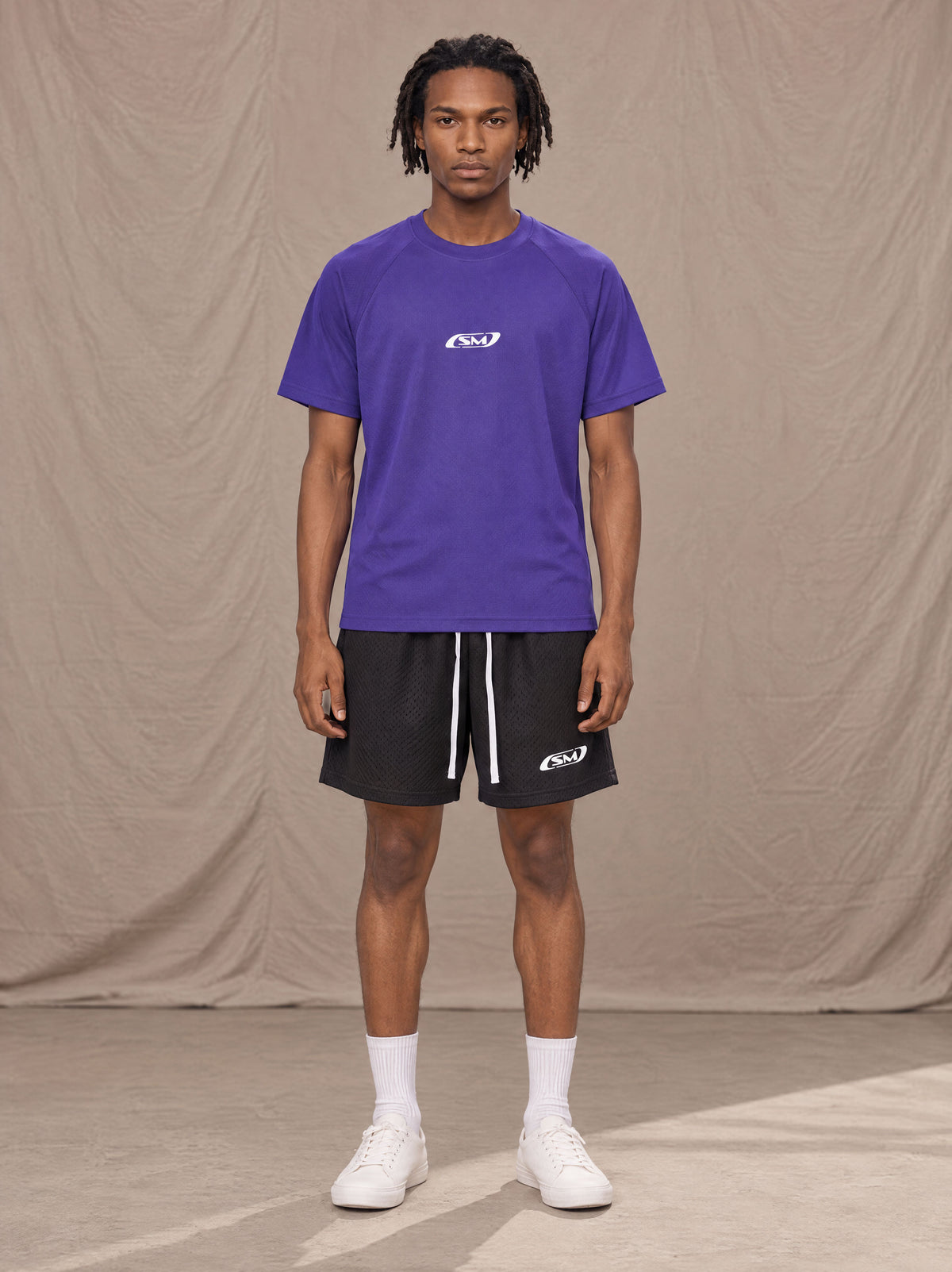 Model wearing the SM Motion Mesh T-shirt in Rich Violet, front view.