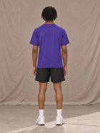 Model wearing the SM Motion Mesh T-shirt in Rich Violet, rear view.