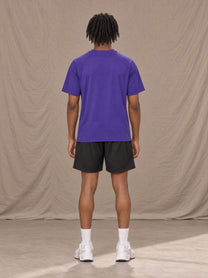 Model wearing the SM Motion Mesh T-shirt in Rich Violet, rear view.