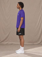 Model wearing the SM Motion Mesh T-shirt in Rich Violet, side profile.