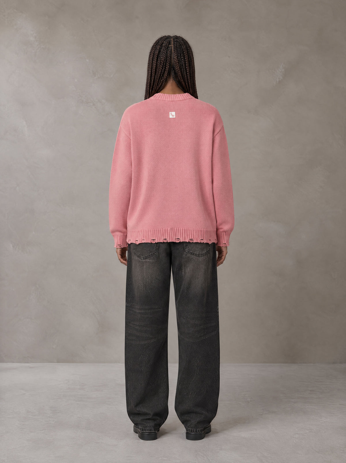 Model wearing the SM Sig. Washed Distress Knit Sweater in Blush Rose, rear view.