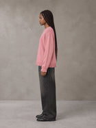 Model wearing the SM Sig. Washed Distress Knit Sweater in Blush Rose, side profile.