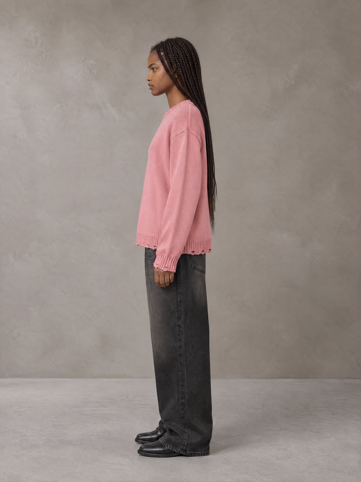 Model wearing the SM Sig. Washed Distress Knit Sweater in Blush Rose, side profile.