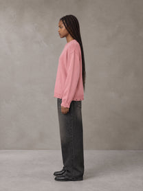 Model wearing the SM Sig. Washed Distress Knit Sweater in Blush Rose, side profile.