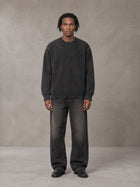 Model wearing the SM Sig. Washed Distress Knit Sweater in Midnight Black, front view.