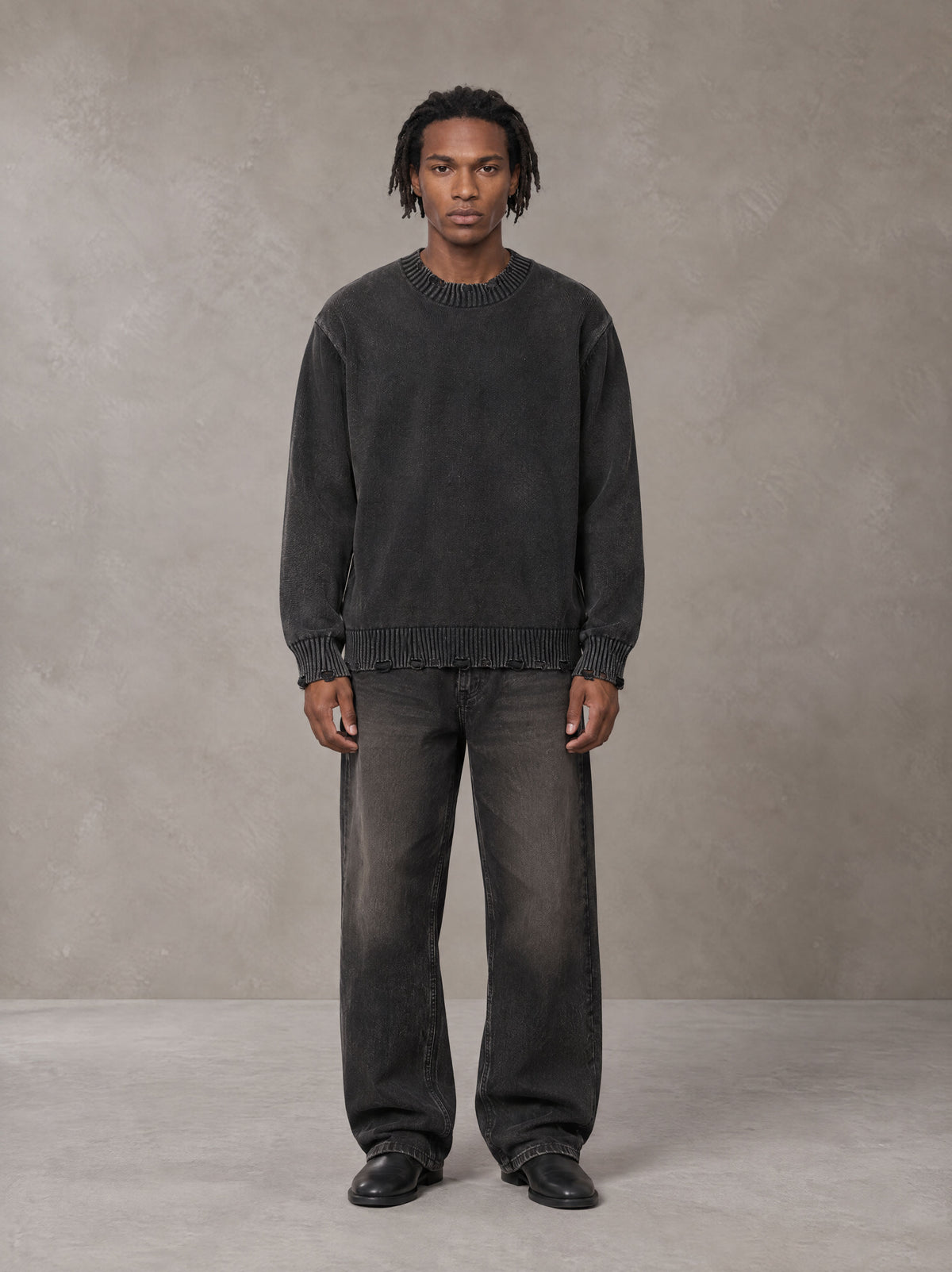 Model wearing the SM Sig. Washed Distress Knit Sweater in Midnight Black, front view.