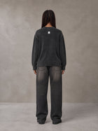 Model wearing the SM Sig. Washed Distress Knit Sweater in Midnight Black, rear view.