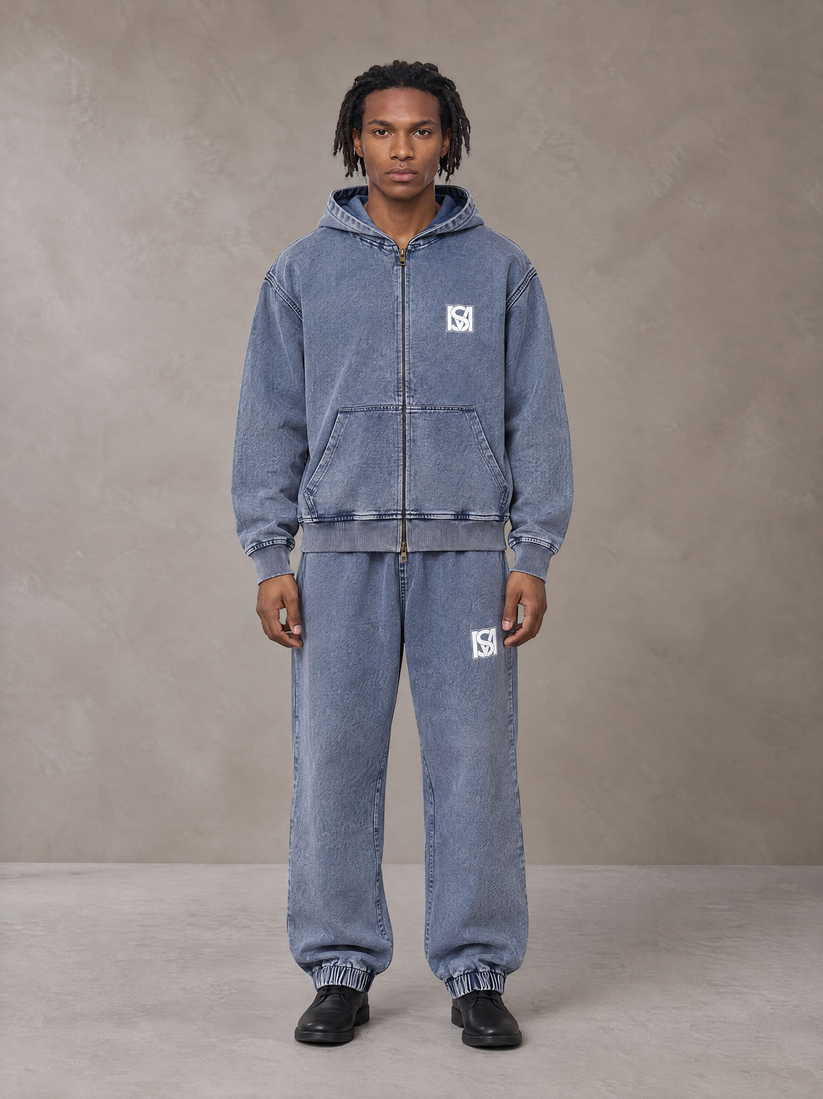 Model wearing the SM Denim Wash Zip Hoodie in Chambray, front view.