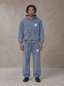 Model wearing the SM Denim Wash Zip Hoodie in Chambray, front view.