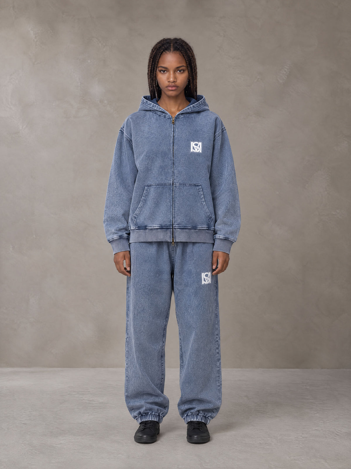 Model wearing the SM Denim Wash Zip Hoodie in Chambray, front view.