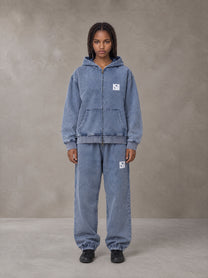 Model wearing the SM Denim Wash Zip Hoodie in Chambray, front view.