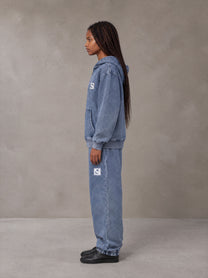 Model wearing the SM Denim Wash Zip Hoodie in Chambray, side profile.
