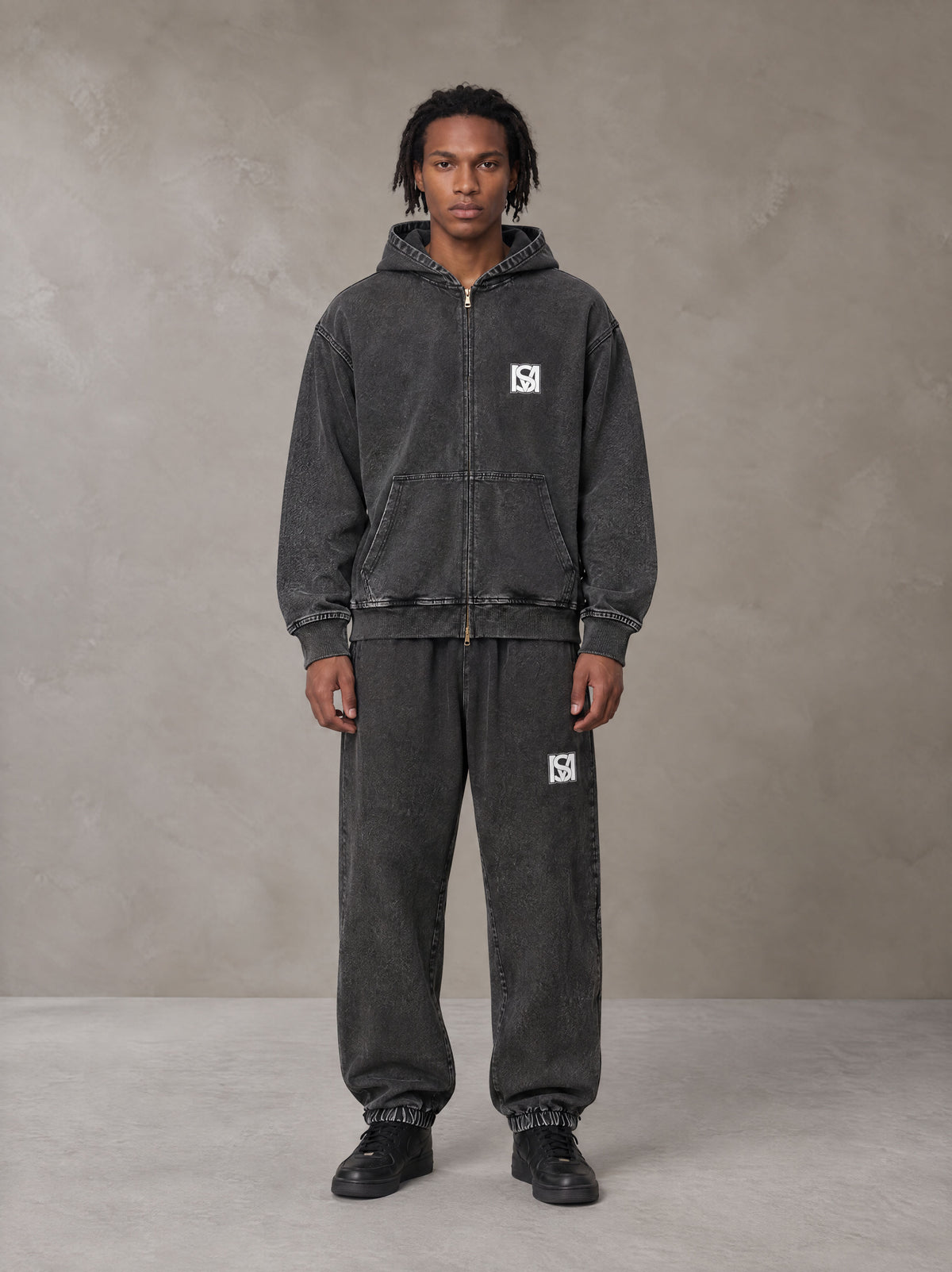 Model wearing the SM Denim Wash Zip Hoodie in Midnight Black, front view.
