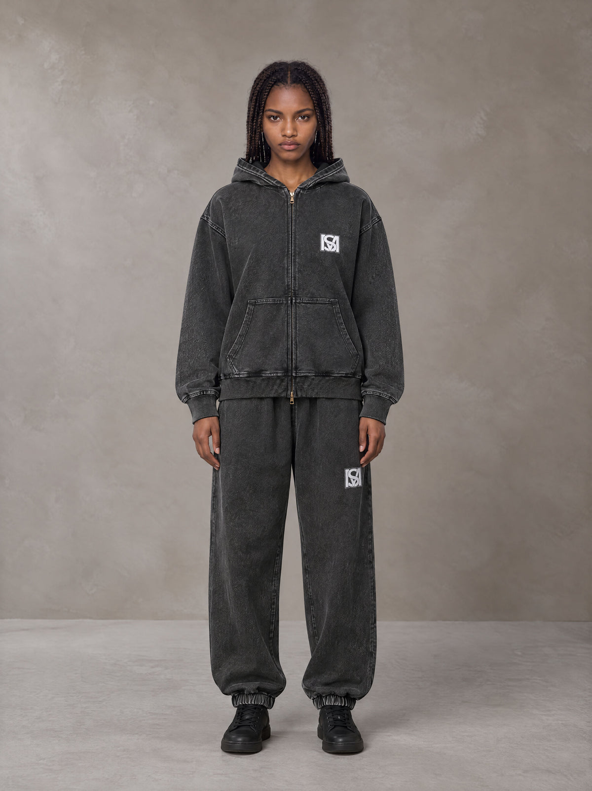 Model wearing the SM Denim Wash Zip Hoodie in Midnight Black, front view.