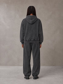 Model wearing the SM Denim Wash Zip Hoodie in Midnight Black, rear view.
