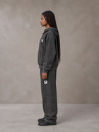 Model wearing the SM Denim Wash Zip Hoodie in Midnight Black, side profile.