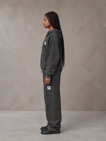 Model wearing the SM Denim Wash Zip Hoodie in Midnight Black, side profile.