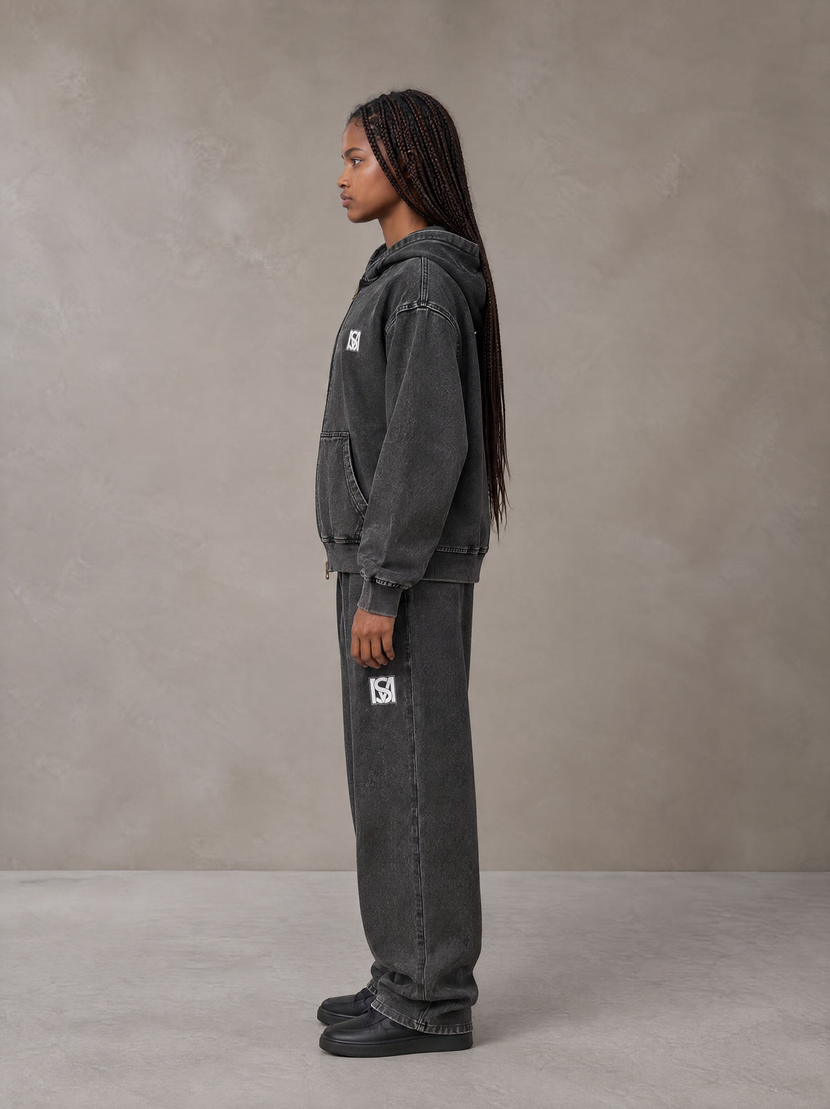 Model wearing the SM Denim Wash Zip Hoodie in Midnight Black, side profile.