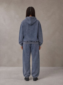 Model wearing the SM Denim Wash Zip Hoodie in Oxford Navy, rear view.