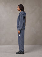 Model wearing the SM Denim Wash Zip Hoodie in Oxford Navy, side profile.