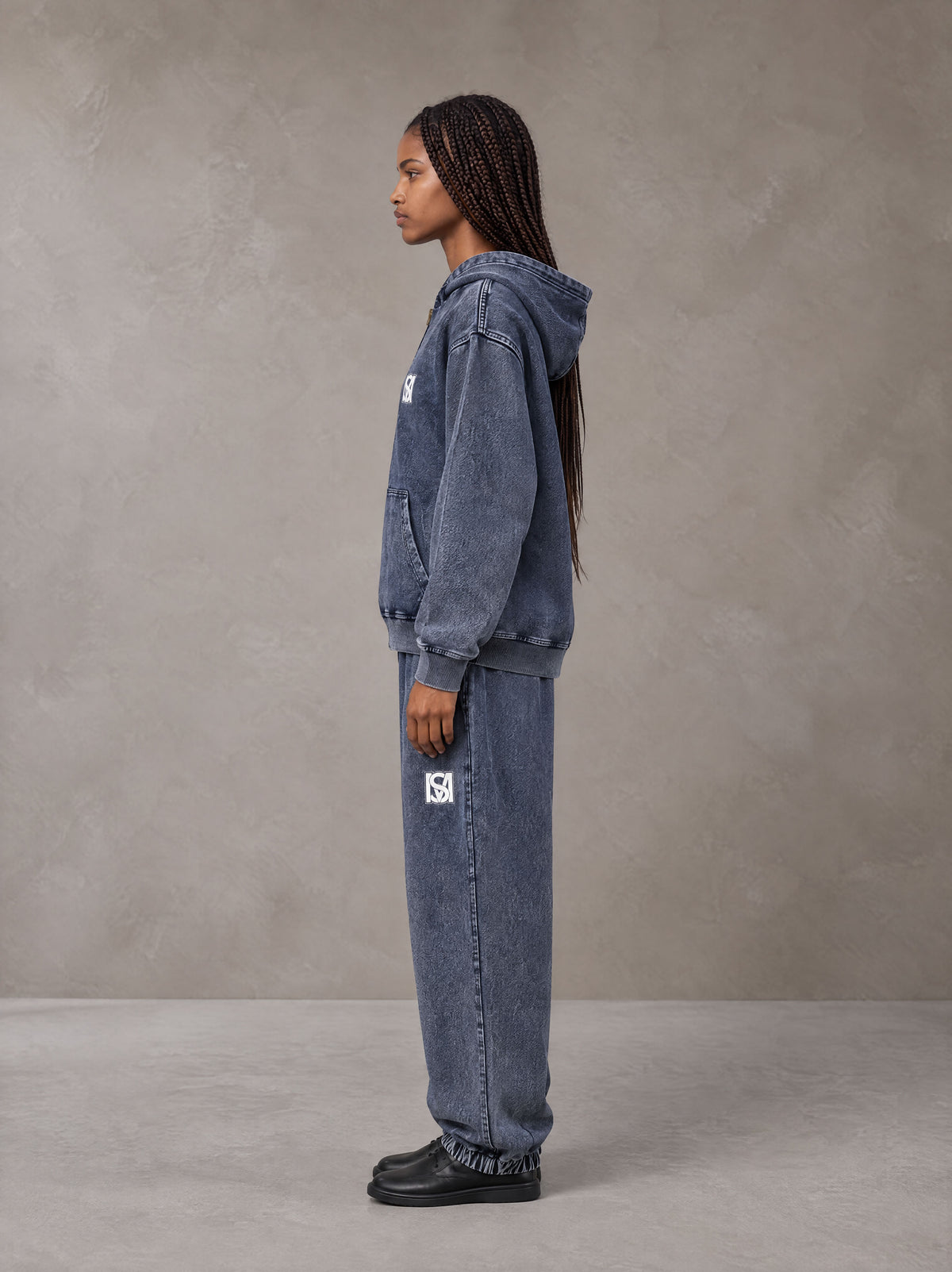 Model wearing the SM Denim Wash Zip Hoodie in Oxford Navy, side profile.