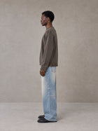 Model wearing the SM Heritage Fade Wide Leg Jeans in Cadet Grey, side profile.