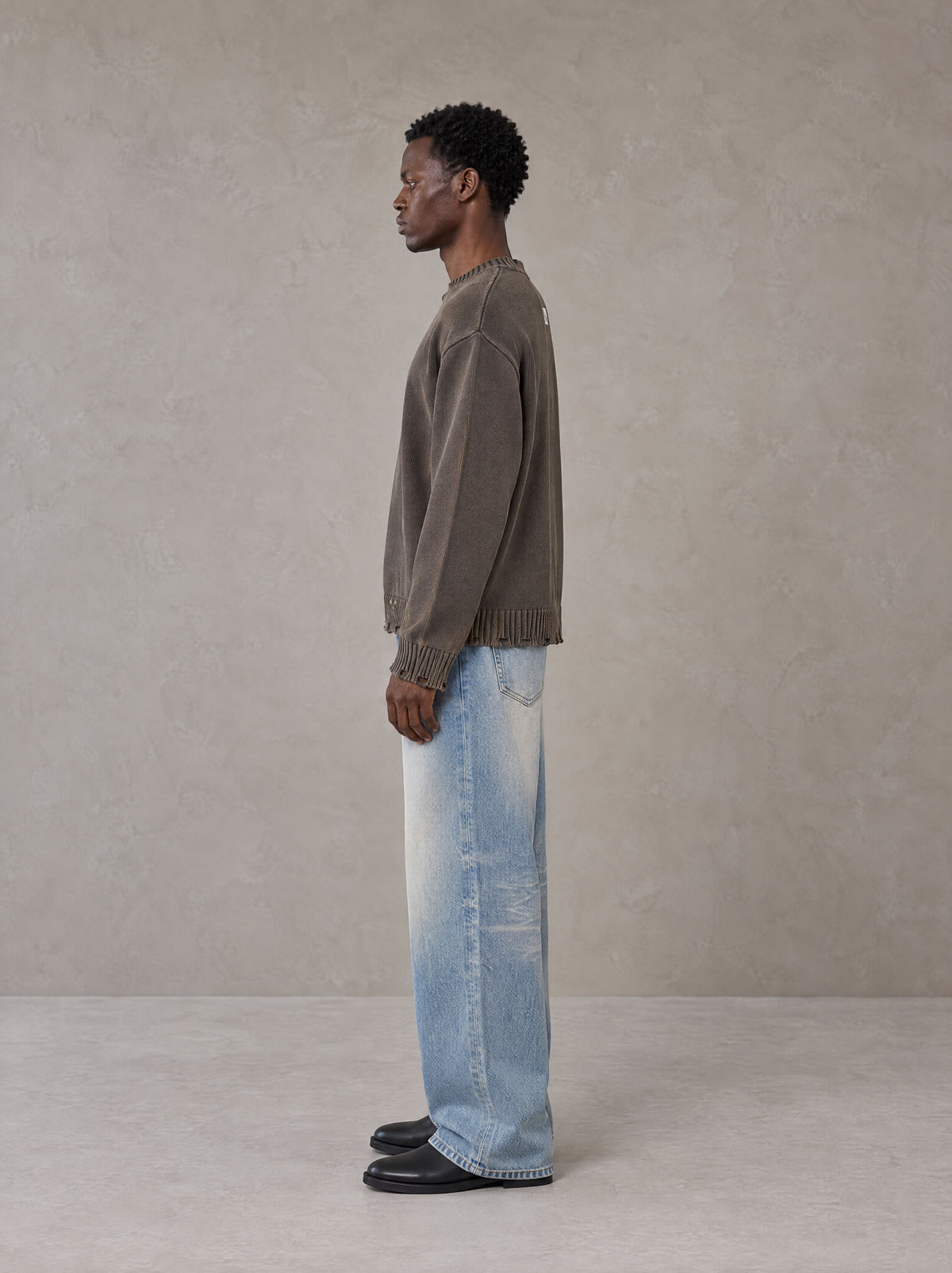 Model wearing the SM Heritage Fade Wide Leg Jeans in Cadet Grey, side profile.