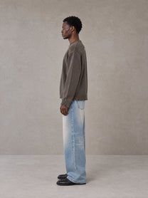 Model wearing the SM Heritage Fade Wide Leg Jeans in Cadet Grey, side profile.