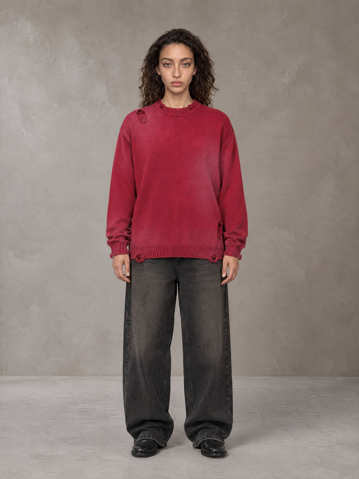 Model wearing the SM Sig. Washed Distress Knit Sweater in Deep Carmine, front view.