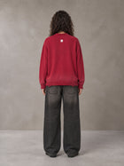 Model wearing the SM Sig. Washed Distress Knit Sweater in Deep Carmine, rear view.