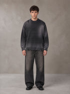 Model wearing the SM Sig. Washed Distress Knit Sweater in Midnight Black, front view.