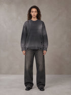 Model wearing the SM Sig. Washed Distress Knit Sweater in Midnight Black, front view.