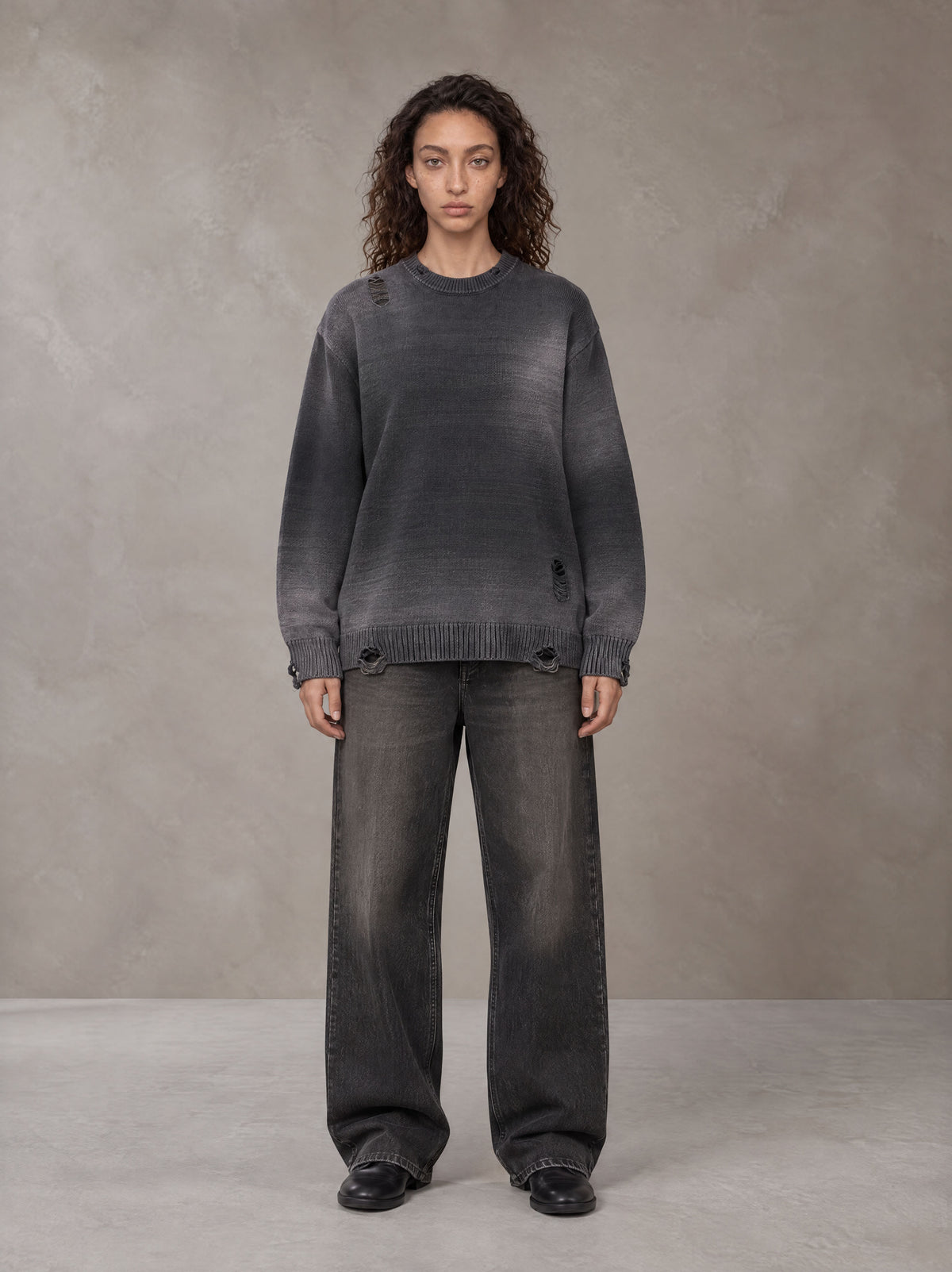 Model wearing the SM Sig. Washed Distress Knit Sweater in Midnight Black, front view.