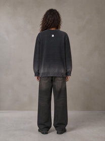 Model wearing the SM Sig. Washed Distress Knit Sweater in Midnight Black, rear view.