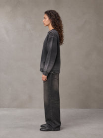 Model wearing the SM Sig. Washed Distress Knit Sweater in Midnight Black, side profile.