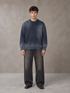 Model wearing the SM Sig. Washed Distress Knit Sweater in Oxford Navy, front view.