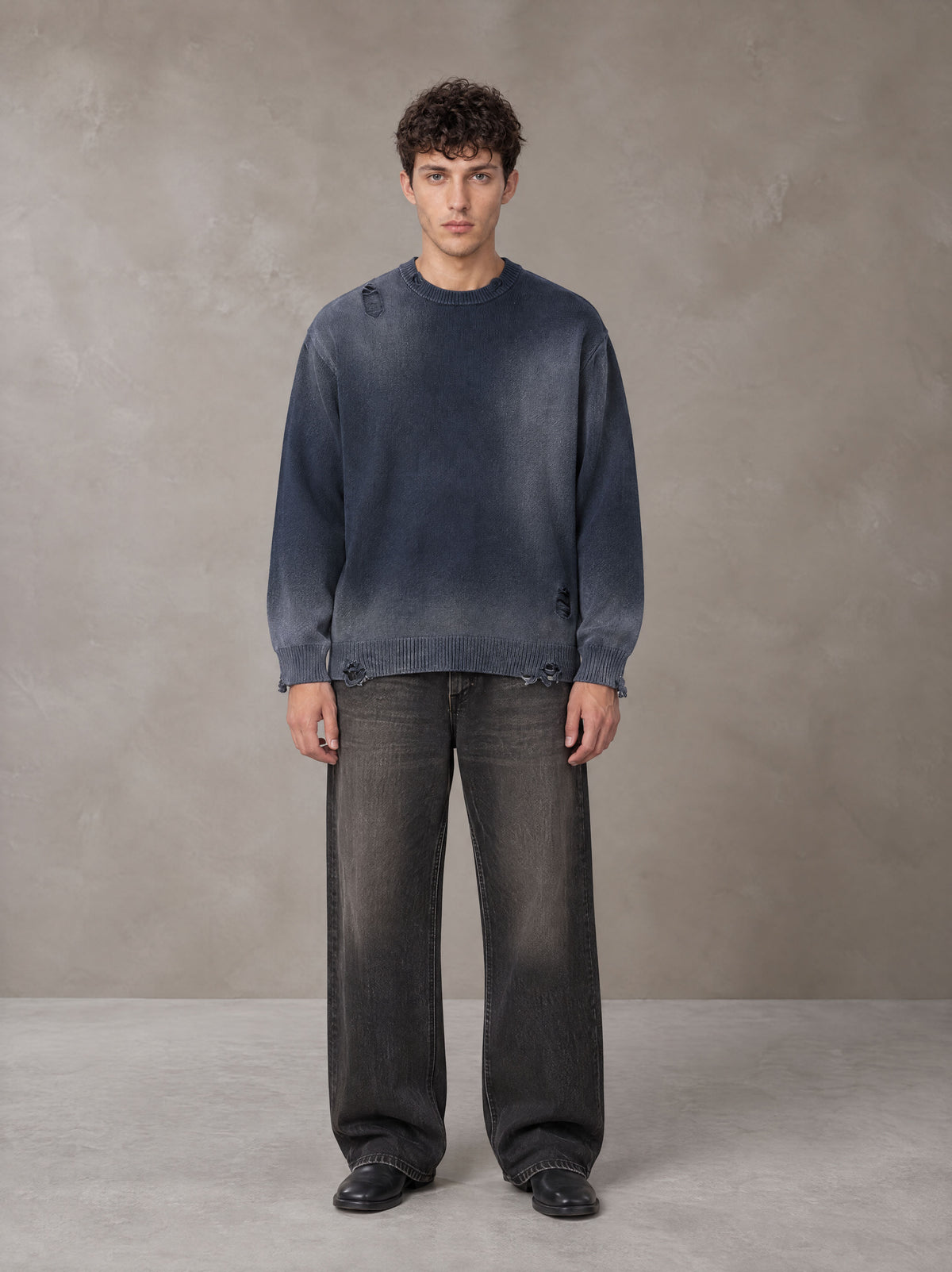 Model wearing the SM Sig. Washed Distress Knit Sweater in Oxford Navy, front view.