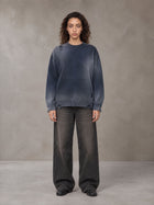 Model wearing the SM Sig. Washed Distress Knit Sweater in Oxford Navy, front view.