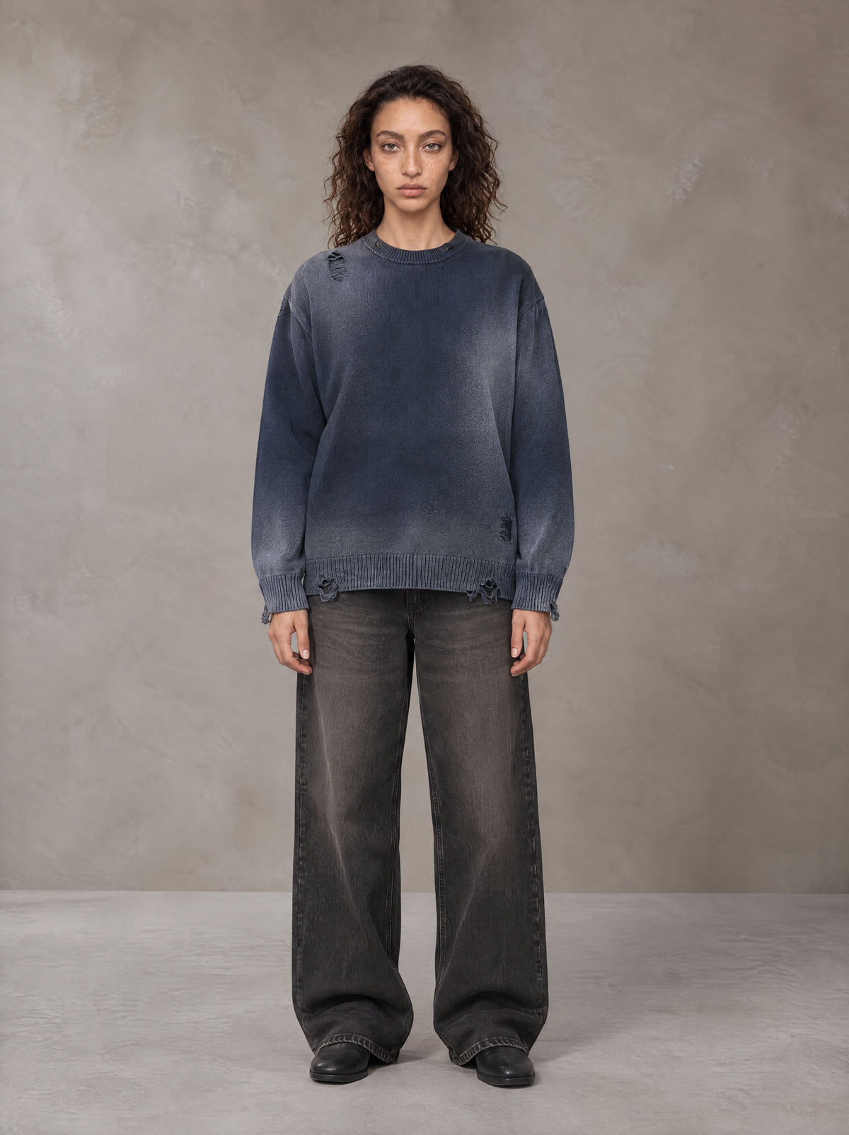 Model wearing the SM Sig. Washed Distress Knit Sweater in Oxford Navy, front view.
