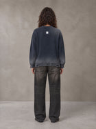 Model wearing the SM Sig. Washed Distress Knit Sweater in Oxford Navy, rear view.
