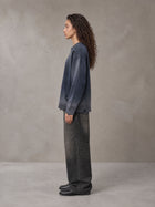 Model wearing the SM Sig. Washed Distress Knit Sweater in Oxford Navy, side profile.