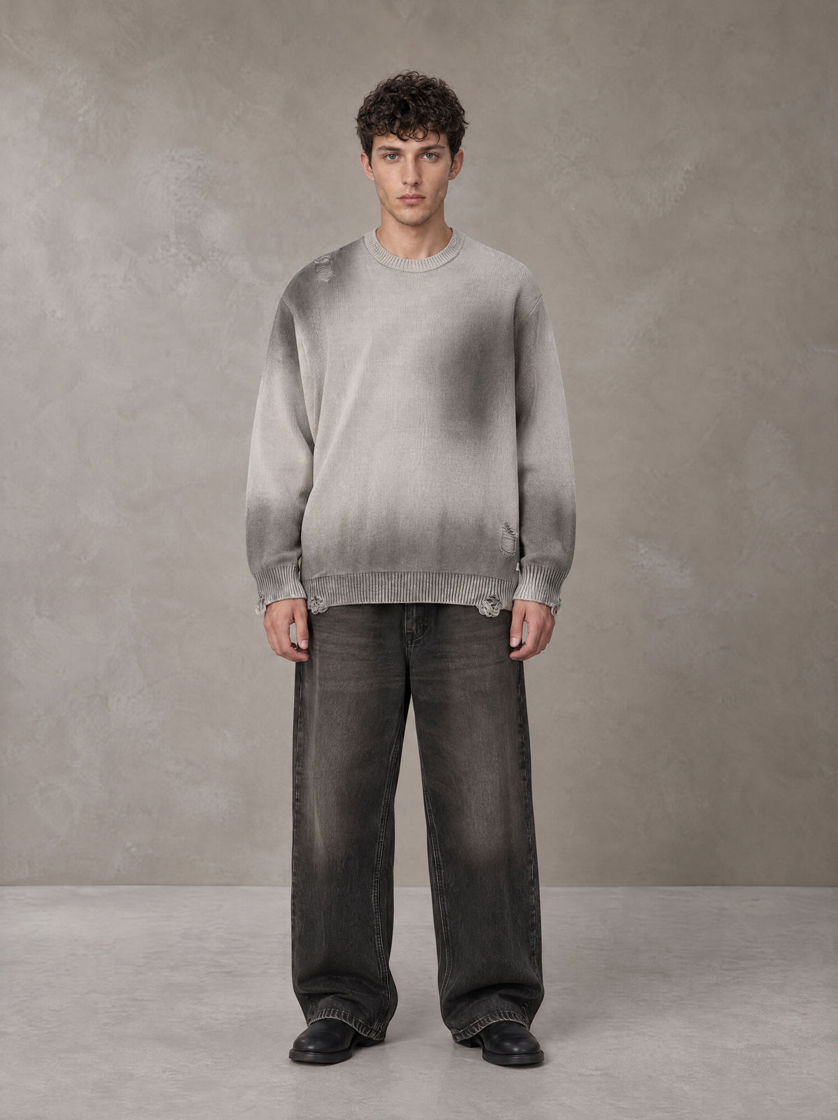 Model wearing the SM Sig. Washed Distress Knit Sweater in Warm Grey, front view.