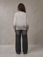 Model wearing the SM Sig. Washed Distress Knit Sweater in Warm Grey, rear view.