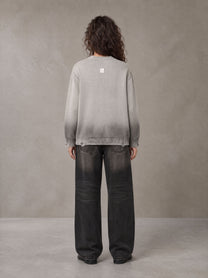 Model wearing the SM Sig. Washed Distress Knit Sweater in Warm Grey, rear view.