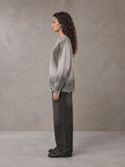 Model wearing the SM Sig. Washed Distress Knit Sweater in Warm Grey, side profile.