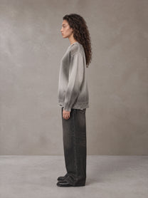 Model wearing the SM Sig. Washed Distress Knit Sweater in Warm Grey, side profile.